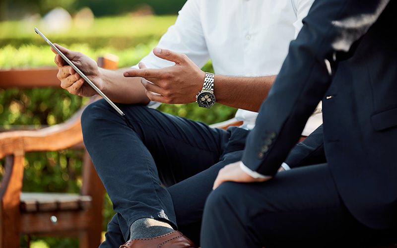 men consulting with tablet